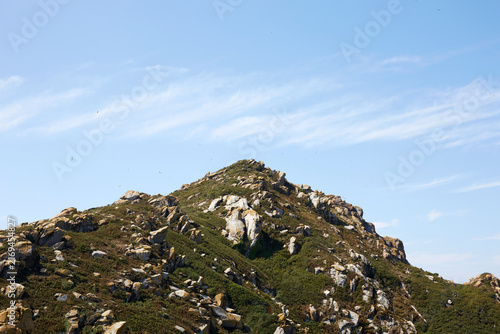 фотографія Rocky granite mountain peak and blue sky in Cies Islands national park Galicia S