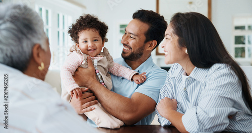 Фотография Baby, smile and grandparent visit in home, laugh and bonding with child for generational love in lounge