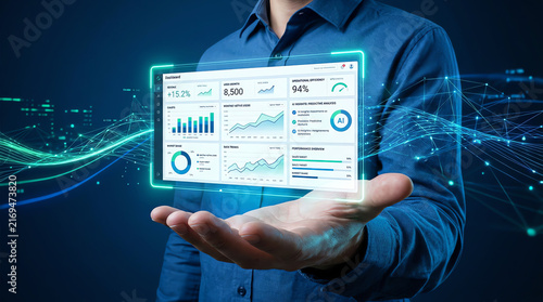 Businessman holding futuristic glowing digital data dashboard interface for analytics