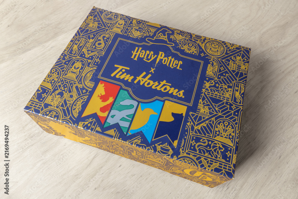 Obraz premium Calgary, Alberta, Canada. August 25, 2026. High angle view of a Harry Potter x Tim Hortons promotional decorative box on a wooden surface.