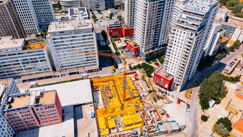 Принти на полотні Busy construction site in urban area with tall buildings surrounding