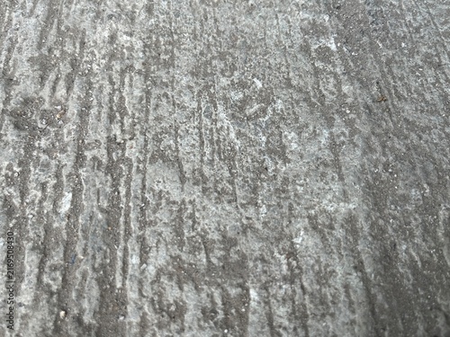 Obraz na plátně A high-angle, top-view photography of a rough, weathered grey concrete or cement surface with vertical grooved lines, creating an industrial abstract texture background