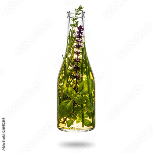 Infusion of Nature: A clear glass bottle filled with a vibrant yellow liquid and fresh green herbs and purple flowers, a testament to natural essences and organic ingredients.
