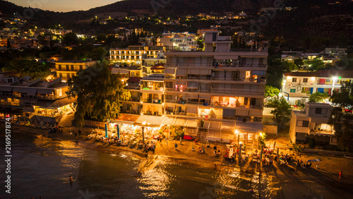 Aerial view of the waterfront of Tolo town in the Peloponnese, Greece on a busy summer night