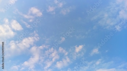 Beautiful clear blue sky with soft white clouds background and copy space