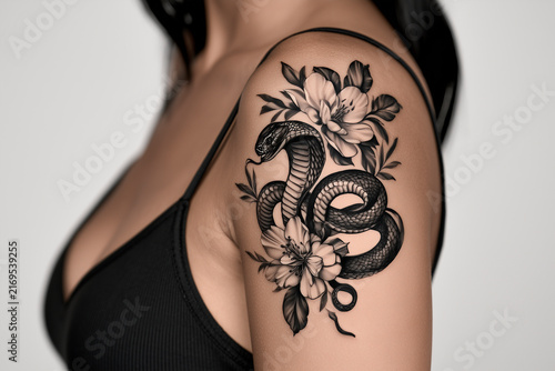Snake And Flowers Tattoo On Upper Arm