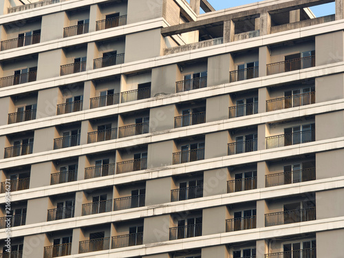 Canvas Print Repeating geometric pattern of balconies on modern high rise building facade, high-density residential property, modern architectural design, and city living