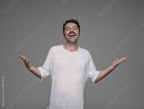 Portrait of arrogant man in front of grey background