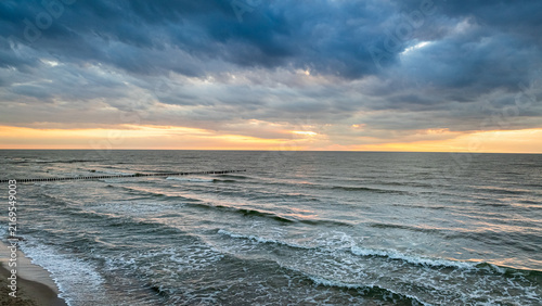 Breathtaking sea waves catching the evening sunset in Poland.