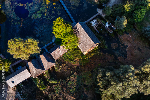 Canvastavla Top down aerial view of old traditional wooden watermills and clear river source at Majerovo Vrilo in Croatia