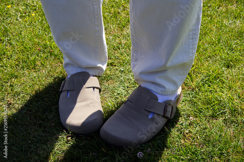 Konstfotografi Trendy hipster fashion of person wearing beige suede clogs with white socks and