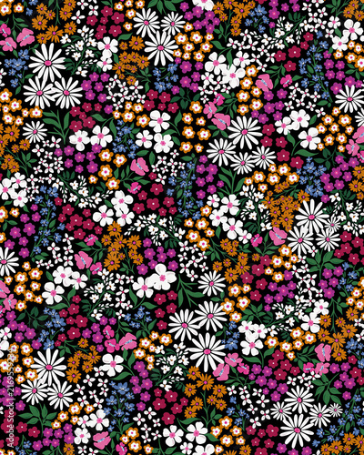 Dense multicolored floral pattern filled with tiny flowers creates a vibrant maximalist botanical texture ideal for fashion, textiles, packaging, wallpaper and eye-catching decorative designs.