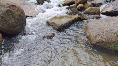 Tranquil Rocky Stream Cascading Through Boulder Filled Landscape In A Picturesque Natural Environment