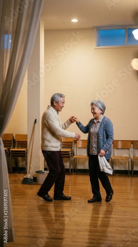 Elderly couple dancing together in warm indoor community setting at a gathering