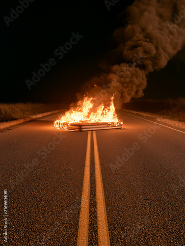 Burning Mattress Blocking Asphalt Road At Night