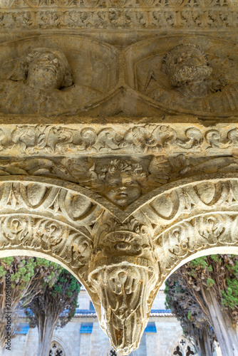 фотографія An intricately carved stone corbel features detailed medieval reliefs