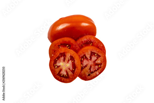 Obraz na płótnie A whole red tomato positioned above several overlapping, thin, circular tomato s