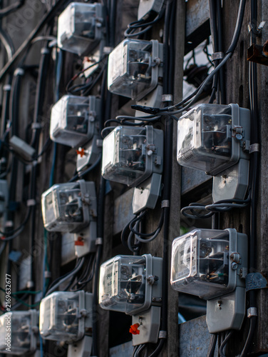 Tangled Electrical Wires and Meters Mounted on Old Utility Pole, Urban Chaos