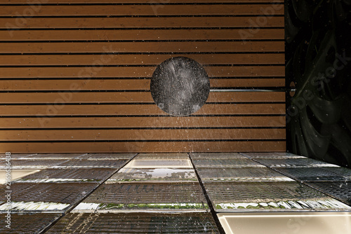 3d Rendering of a modern shower room with glass cubes wall and shower head from below