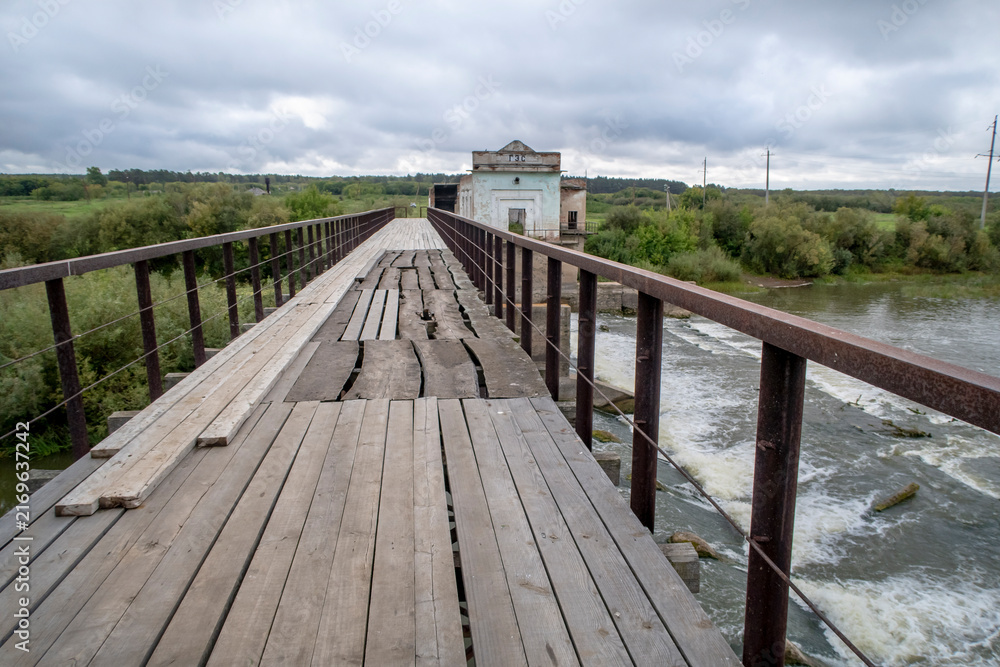 Fototapeta premium View of the dam of the abandoned Kiik Hydroelectric Power station under a stormy sky