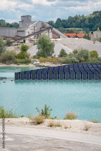 Obraz na plátně Vertical floating solar panels on the Gilching quarry lake in Bavaria, Germany,
