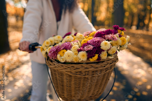 Bicycle basket filled with autumn flowers.