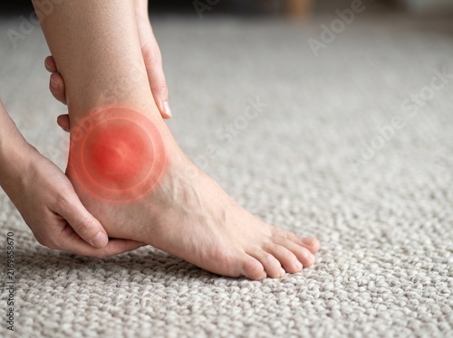 Close up of a persons ankle with a red inflamed area indicating pain and injury.