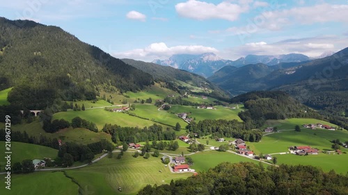 Aerial drone view of the idyllic Bavarian Alps near Ramsau bei Berchtesgaden, Germany, featuring lush green alpine meadows, narrow country roads and mountain scenery. Slow, smooth and relaxing