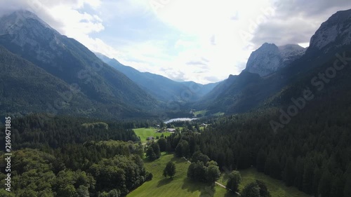 Aerial drone view of Hintersee lake near Ramsau bei Berchtesgaden in Bavaria, Germany, surrounded by dense coniferous forests and majestic Alpine mountains. Peaceful and scenic landscape