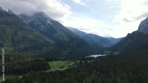 Aerial drone view of Hintersee lake near Ramsau bei Berchtesgaden in Bavaria, Germany, surrounded by dense coniferous forests and majestic Alpine mountains. Peaceful and scenic landscape