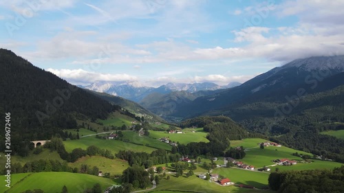 Aerial drone view of the idyllic Bavarian Alps near Ramsau bei Berchtesgaden, Germany, featuring lush green alpine meadows, narrow country roads and majestic mountain scenery. Peaceful rural landscape