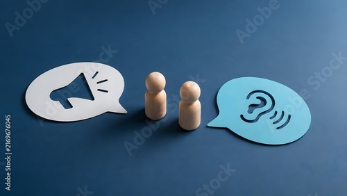 Effective communication concept featuring wooden figures with megaphone and ear icons symbolizing public speaking and attentive listening
