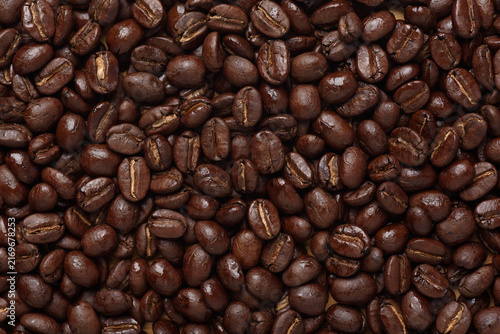 Top view of medium roast coffee beans texture background. High quality roasted arabica coffee beans for background and wallpaper
