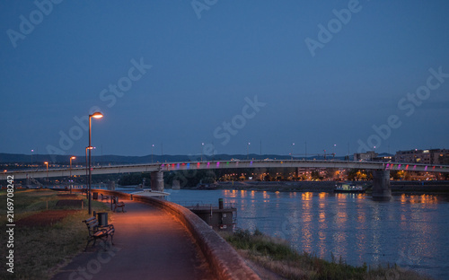 Varadin bridge over Danube river at twilight with city lights reflections. Novi Sad, Serbia