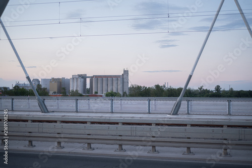 Bridge view of industrial complex with grain silos at dusk. Novi Sad, Serbia