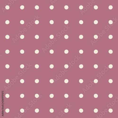 Seamless polka dot pattern on a muted pink background for design and decor