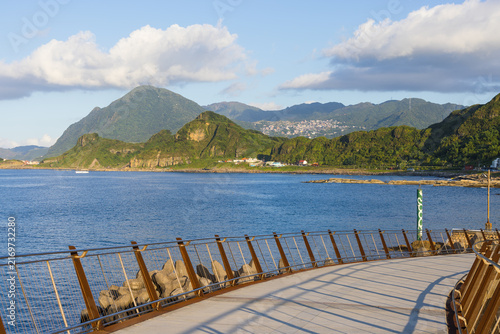 Photography Scenic coastal boardwalk and green mountains in Keelung
