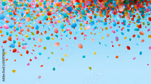 Vibrant confetti cascading down on a soft blue backdrop perfect for festive occasions and celebrations
