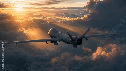Military drone flying in dramatic sunset sky with vibrant clouds and golden sun rays illuminating.