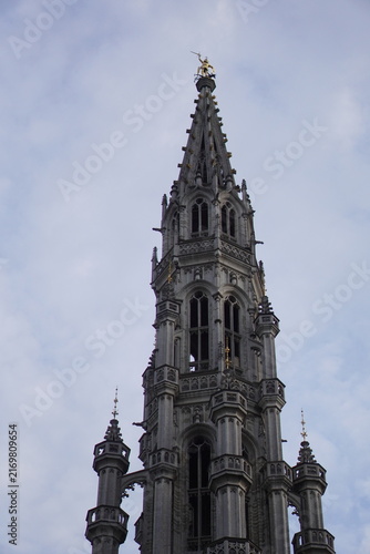 Bild auf Leinwand Tall Gothic church spire rising above the historic city center of Brussels, Belgium