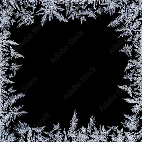 Frosty frame overlay. Square frame of delicate frost on a black background with copy space. Perfect for winter cards, invitations, posters, photos and seasonal designs.