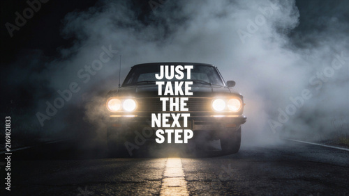 Classic car with glowing headlights on a dark misty road under text quote 