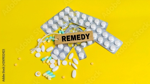 Paper label with remedy text on various pills.