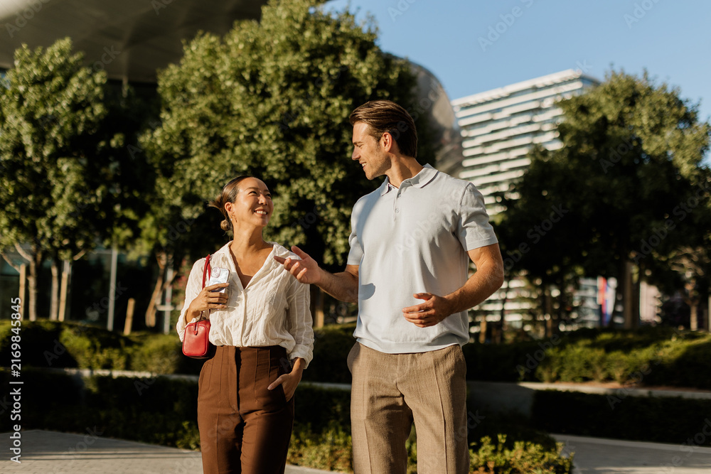Fototapeta premium Joyful moments shared between a Korean woman and Caucasian man under the sun