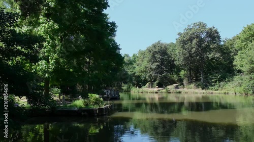 Serene lake reflecting the lush green trees of Ataturk Arboretum in Istanbul on a sunny day