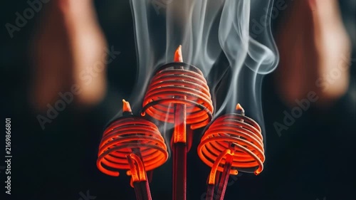 Burning Spiral Incense Coils with Rising Smoke