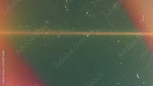 Animated fast light leak transition with horizontal orange film burn, green background, and dust particles for 4K video overlays.