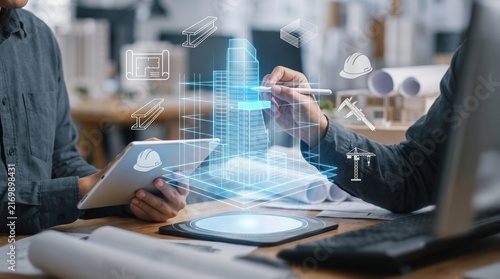 Architects using holographic building model for construction project planning and design