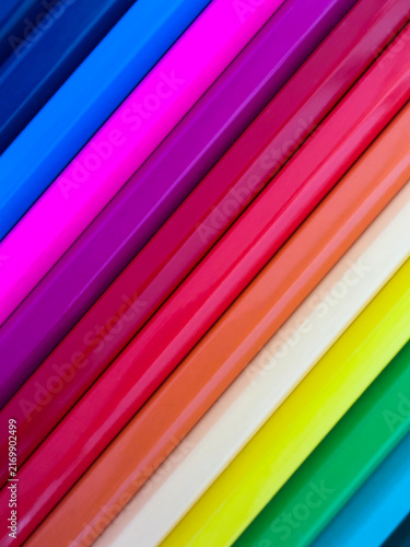 Colorful pencils arranged diagonally as vibrant abstract background