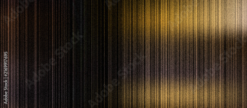 A close-up view of a textured, metallic surface with golden lighting effects